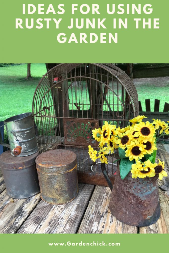Rusty garden containers look great with the fall colors of orange and yellow. They stand out against the brown rusty color