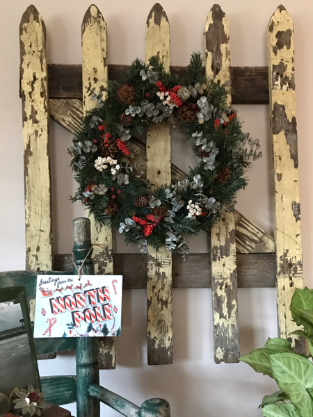 Place a Christmas wreath on an old gate to create vintage Christmas decor
