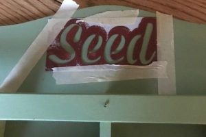 Stencil "seed" on the letter holder which will hold seed packets